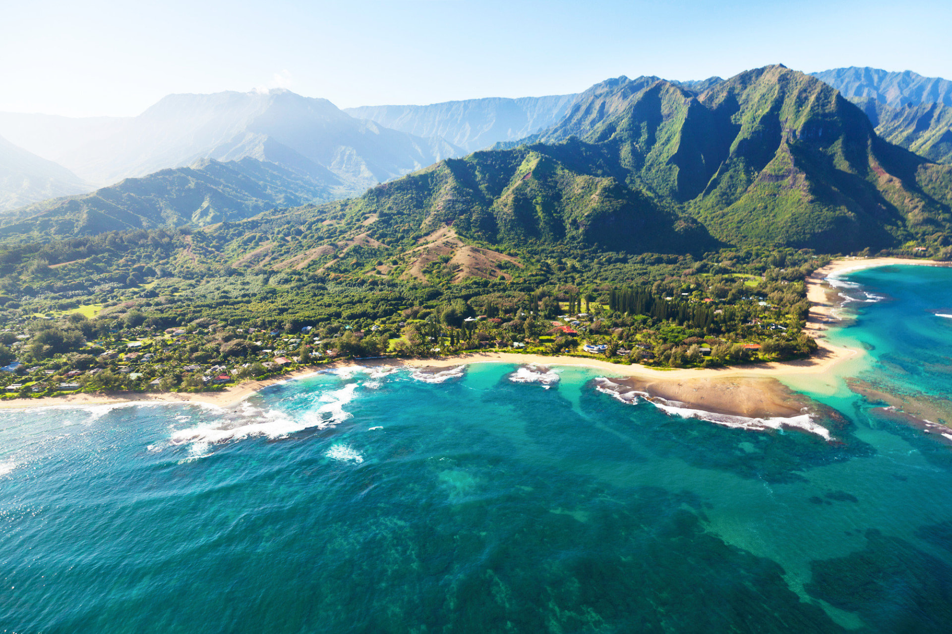 Aerial view of the Big Islandʻs dramatic green coastline and turquoise ocean